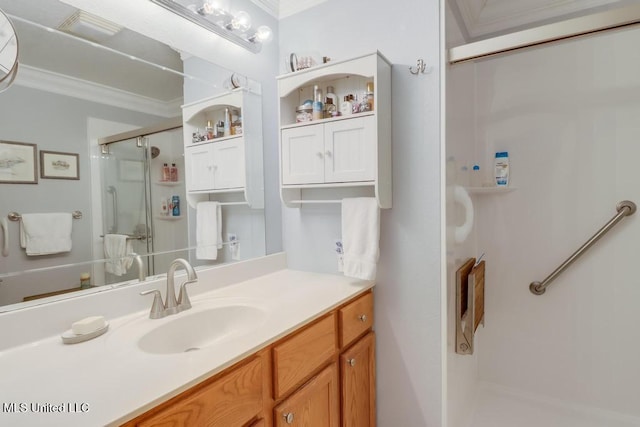 bathroom with vanity, crown molding, and a shower with door