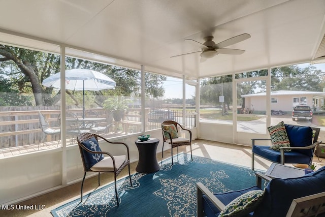 sunroom / solarium with a wealth of natural light and ceiling fan