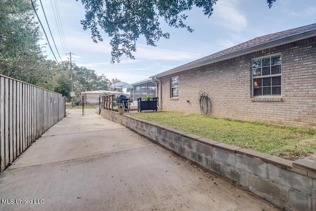 view of side of home featuring a lawn