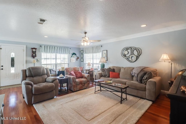 living room featuring crown molding, ceiling fan, dark hardwood / wood-style floors, and a textured ceiling