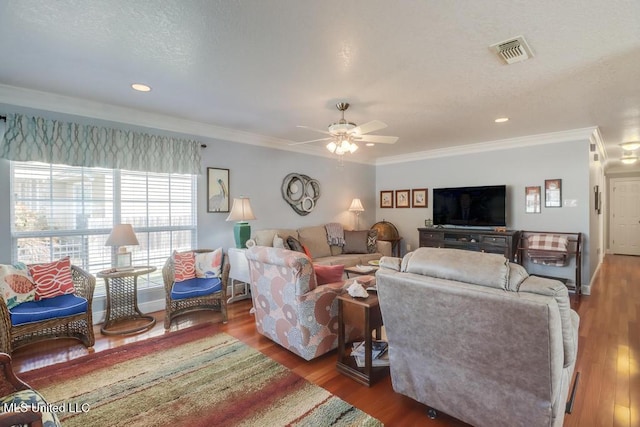 living room featuring hardwood / wood-style floors and crown molding