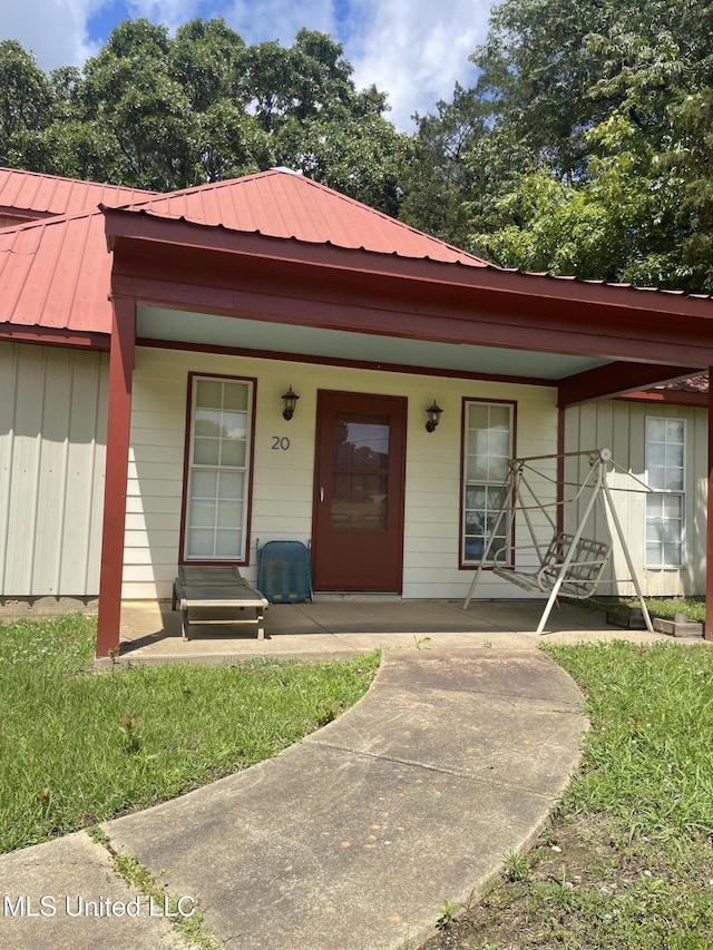20 Cedar Hts, Pope, MS 38658 - view of front of home with covered porch, board and batten siding, and metal roof