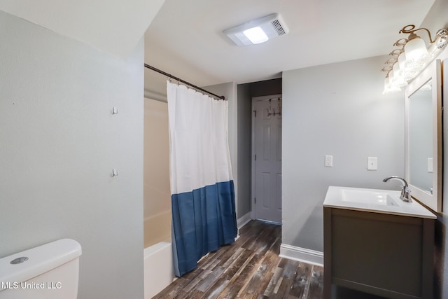 full bathroom with vanity, wood finished floors, visible vents, baseboards, and toilet