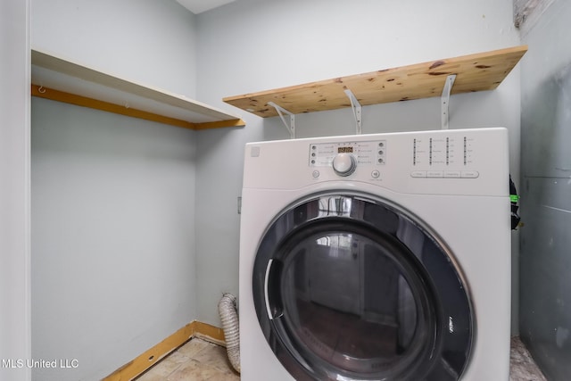 laundry area featuring light tile patterned floors, baseboards, washer / dryer, and laundry area