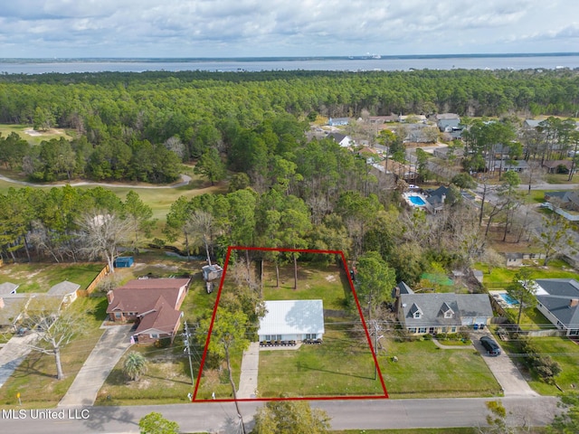 drone / aerial view featuring a water view and a view of trees