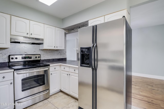 kitchen featuring dark countertops, backsplash, under cabinet range hood, appliances with stainless steel finishes, and white cabinets