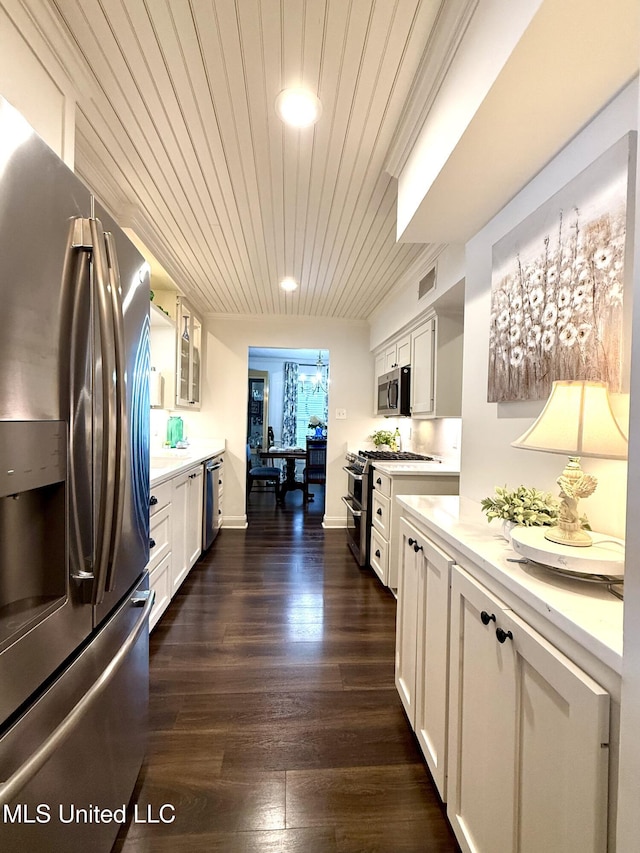 kitchen featuring stainless steel appliances, light countertops, white cabinetry, glass insert cabinets, and wooden ceiling
