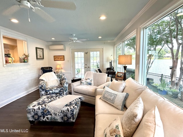 living area featuring a ceiling fan, ornamental molding, a wall mounted air conditioner, french doors, and wood finished floors