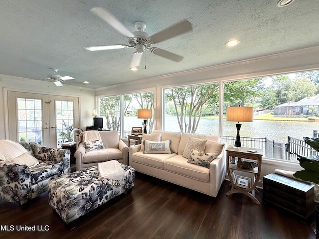 living area featuring french doors, a textured ceiling, ceiling fan, crown molding, and wood finished floors
