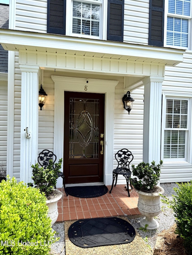 doorway to property featuring covered porch