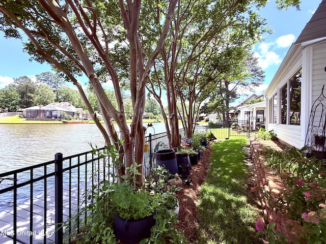 view of yard with a water view and fence