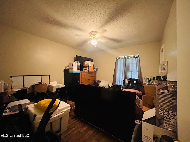 bedroom featuring dark hardwood / wood-style flooring, a textured ceiling, and ceiling fan