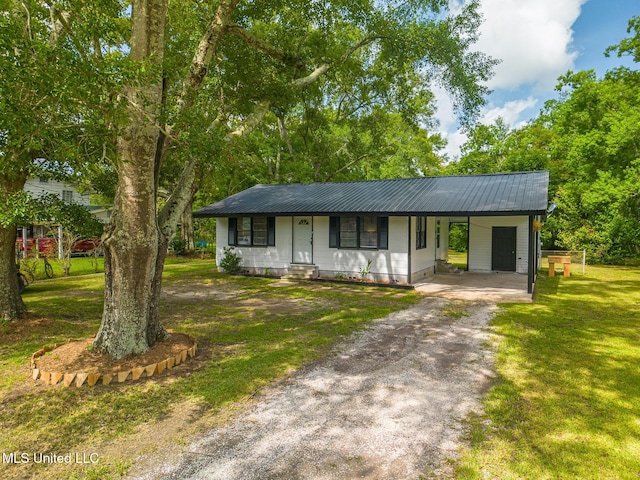 ranch-style house with a front yard and a carport