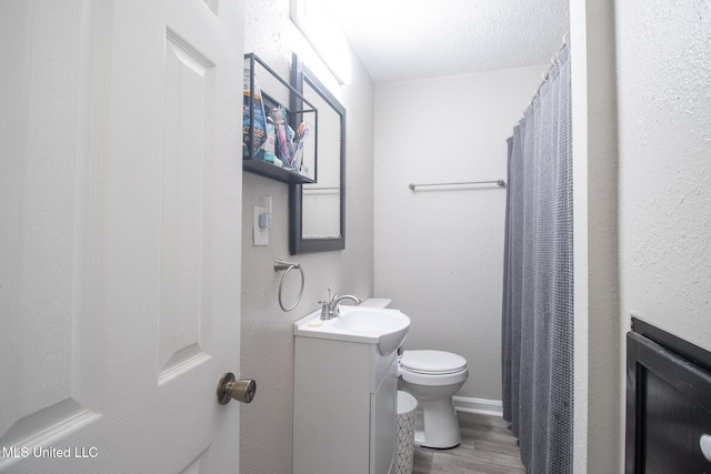 bathroom featuring vanity, hardwood / wood-style flooring, and toilet