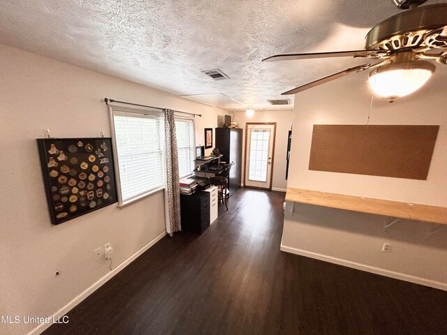 hall featuring a textured ceiling and dark hardwood / wood-style flooring