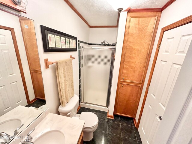 bathroom featuring toilet, a textured ceiling, walk in shower, and vanity