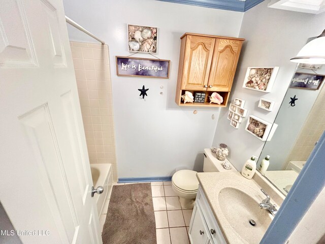 full bathroom with tiled shower / bath, toilet, vanity, crown molding, and tile patterned floors