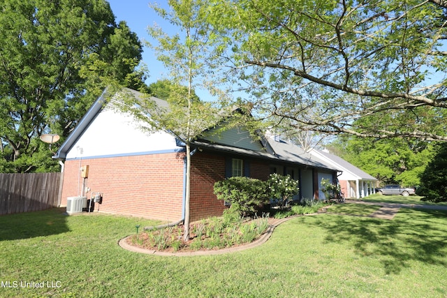 view of home's exterior with a yard and central AC unit