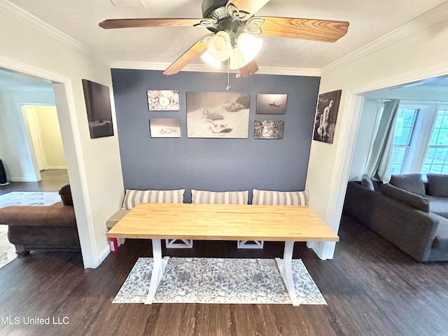 dining space featuring ornamental molding, dark wood-type flooring, and ceiling fan