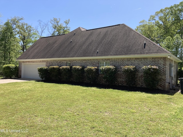 view of side of property featuring brick siding, a lawn, concrete driveway, an attached garage, and roof with shingles