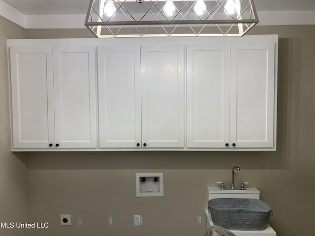clothes washing area with cabinet space, hookup for a washing machine, and electric dryer hookup
