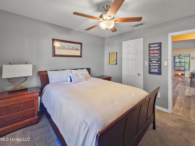 881 Brentwood Dr, Biloxi, MS 39532 - bedroom featuring carpet floors, a textured ceiling, and ceiling fan