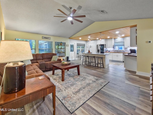 881 Brentwood Dr, Biloxi, MS 39532 - living area with lofted ceiling, ceiling fan, wood finished floors, and recessed lighting