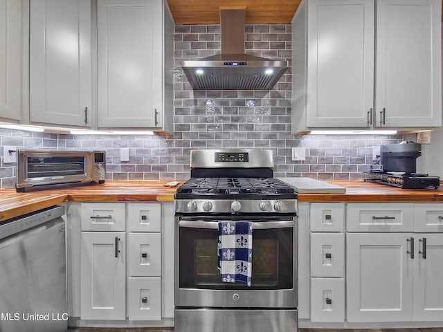 881 Brentwood Dr, Biloxi, MS 39532 - kitchen featuring butcher block countertops, stainless steel appliances, wall chimney exhaust hood, and tasteful backsplash