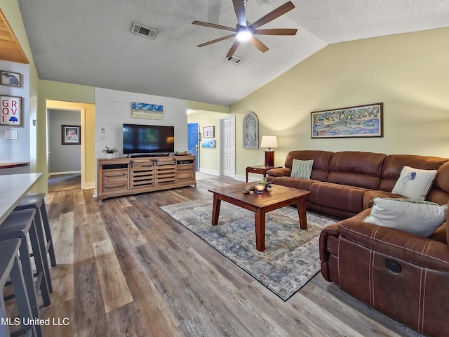 881 Brentwood Dr, Biloxi, MS 39532 - living area featuring a ceiling fan, vaulted ceiling, wood finished floors, and a textured ceiling