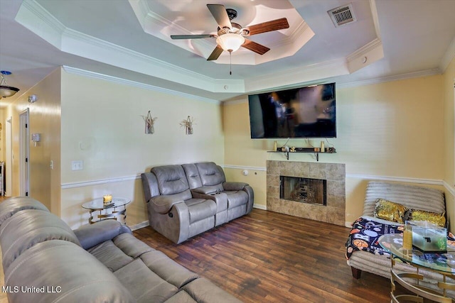 6 Laurie Cv, Byram, MS 39272 - living area featuring a tray ceiling, a ceiling fan, wood finished floors, crown molding, and a tile fireplace
