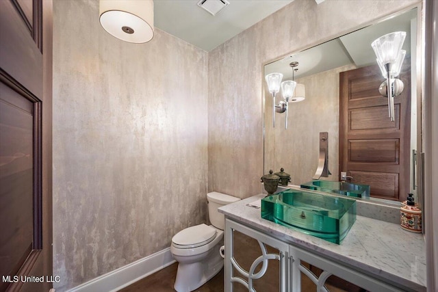 bathroom featuring vanity and toilet