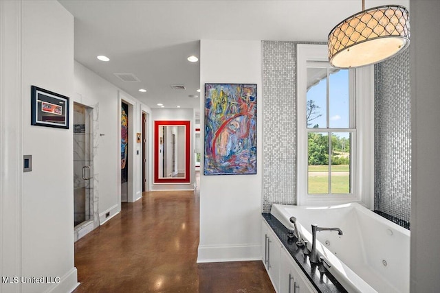 145 Republic St Unit 331, Madison, MS 39110 - bathroom featuring baseboards, concrete flooring, recessed lighting, a jetted tub, and a stall shower