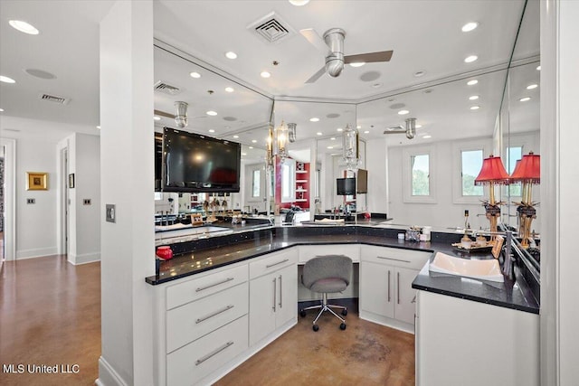 bathroom featuring ceiling fan, sink, and concrete flooring