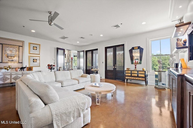 living room featuring french doors, concrete flooring, and ceiling fan