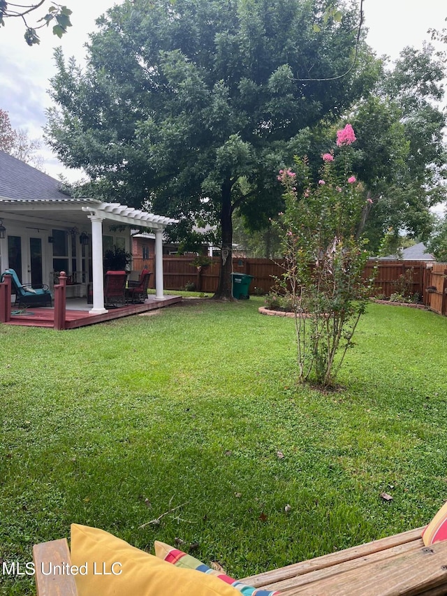 view of yard featuring a patio and a wooden deck