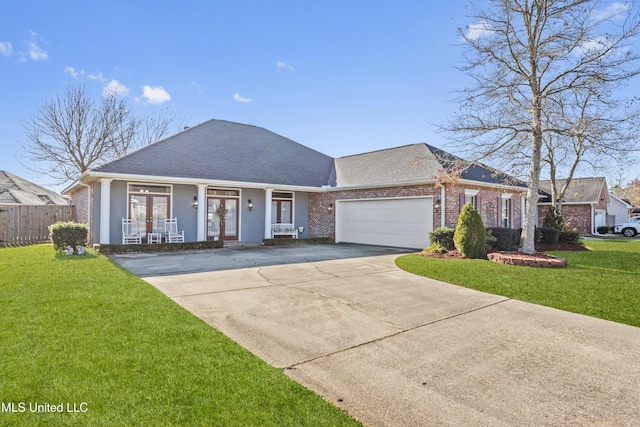 single story home with a garage, covered porch, and a front lawn