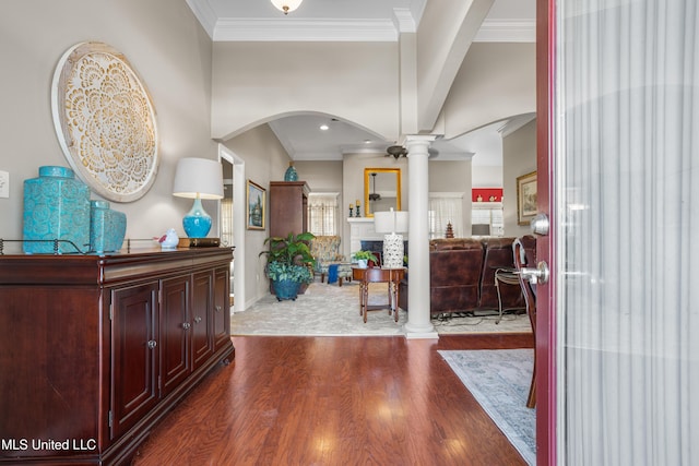 entryway featuring dark hardwood / wood-style flooring, ornate columns, and crown molding