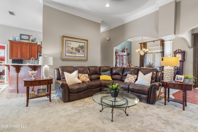 living room featuring ornate columns, sink, crown molding, light colored carpet, and a chandelier