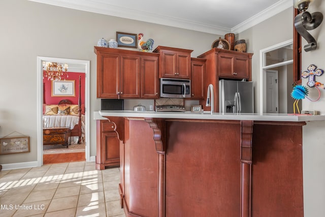 kitchen with ornamental molding, tasteful backsplash, light tile patterned flooring, stainless steel appliances, and a chandelier