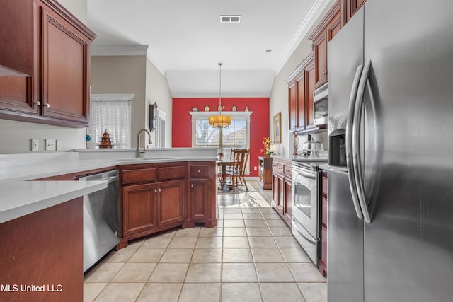 kitchen with stainless steel appliances, sink, decorative light fixtures, lofted ceiling, and light tile patterned flooring