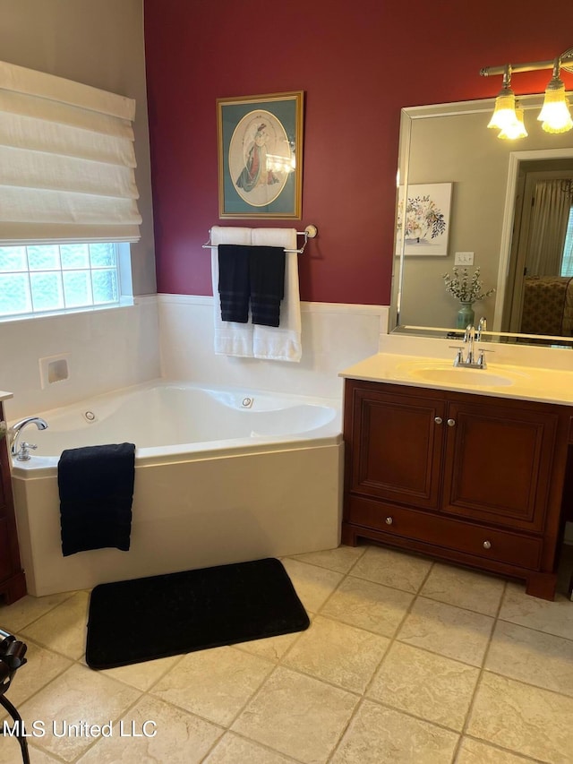 bathroom with tile patterned flooring, a bath, and vanity