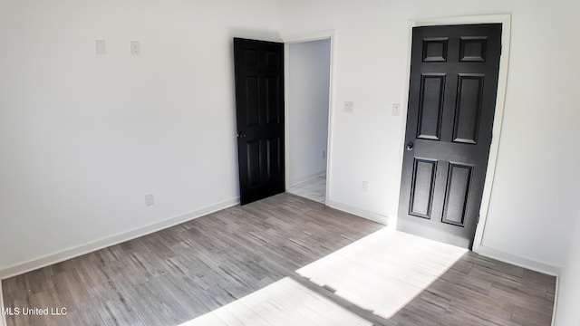 spare room featuring light hardwood / wood-style flooring