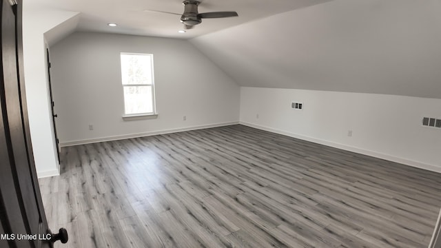 additional living space featuring vaulted ceiling, ceiling fan, and light wood-type flooring