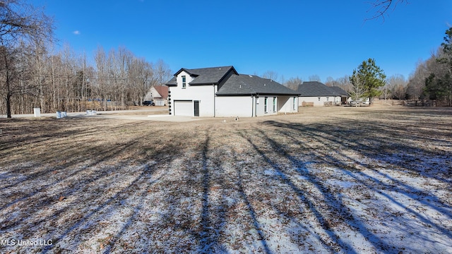 snow covered property featuring a garage