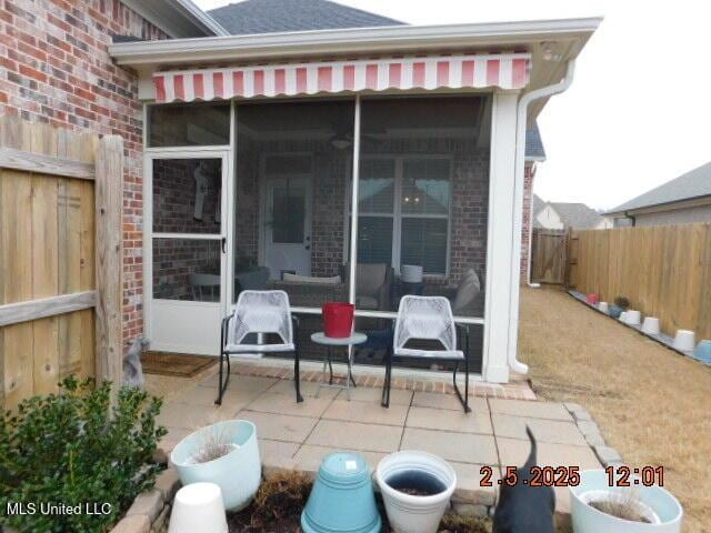 view of patio / terrace with a sunroom