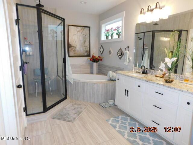 bathroom featuring vanity and shower with separate bathtub