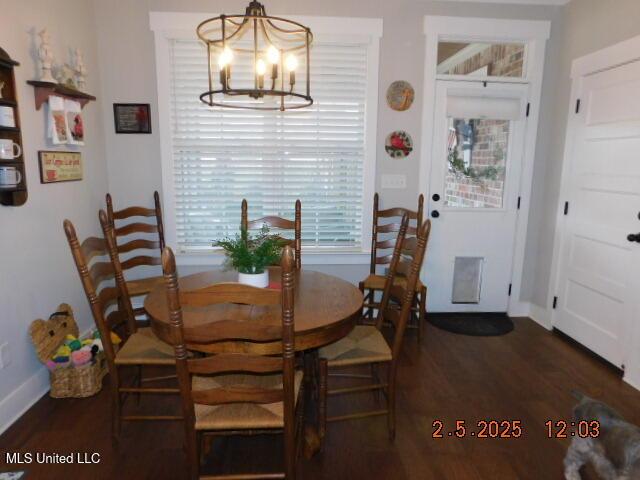 dining room featuring dark hardwood / wood-style floors and a notable chandelier