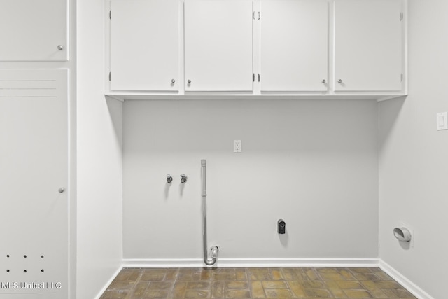 clothes washing area with washer hookup, baseboards, and cabinet space