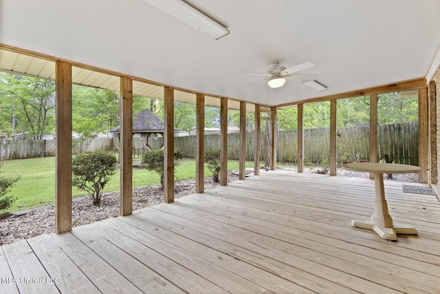 deck featuring a yard, a fenced backyard, an outbuilding, and ceiling fan