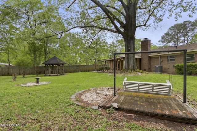 view of yard featuring a gazebo, a fenced backyard, and central AC